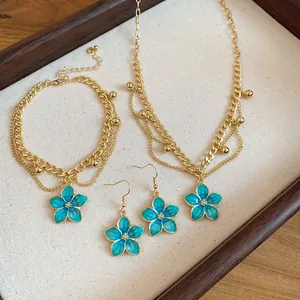 Detailed macro view of blue enamel flower jewelry set with necklace and bracelet