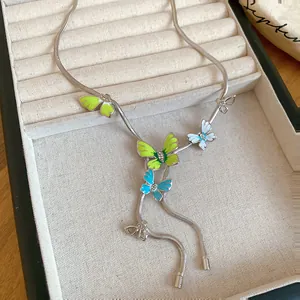 Detailed macro view of an enamel butterfly necklace with rhinestones in jewelry box