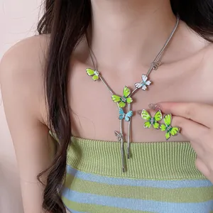 Close-up of green enamel butterfly necklace and earring set with sparkling crystals