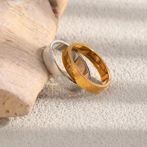 Detailed view of gold and silver stainless steel rings with starfish engravings