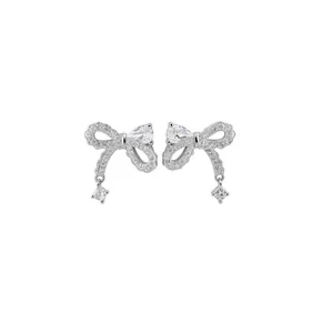 Elegant silver bow earrings with shimmering zircon stones and dangling square crystals