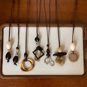 Diverse collection of boho resin geometric pendant necklaces with natural wooden textures