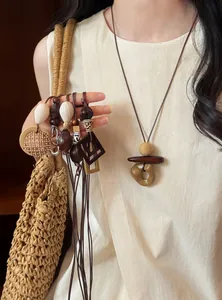 Close-up of summer resin geometric pendant necklaces with minimalist cord chains