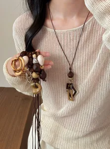 Macro shot of a minimalist boho resin geometric pendant necklace worn by a female model