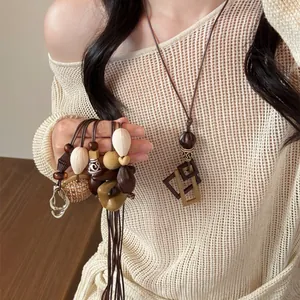 Close-up of creative resin geometric pendant necklaces shown on a model's outfit