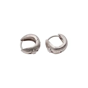 Textured silver hoop earrings with star-set cubic zirconia on a clean white background.