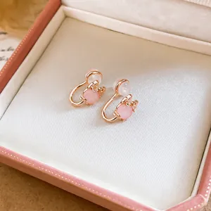 Elegant pink cat eye stone clip-on earrings with rose gold plating presented in a gift box