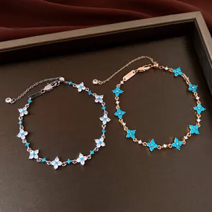 Close-up detail of 18k gold plated flower bracelets with blue and white zircon stones