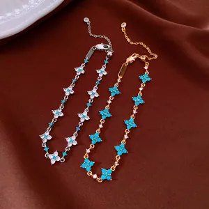 Close-up of 18k gold plated bracelets with turquoise flowers and sparkling cubic zirconia
