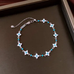 Close-up detail of an elegant flower bracelet with zirconia and turquoise stones