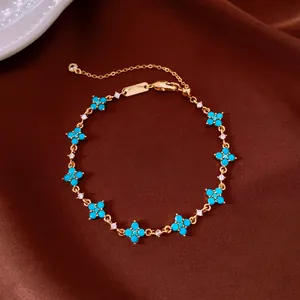 Close-up of 18k gold plated bracelet with turquoise-colored zircon flower charms