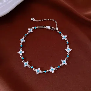 Close-up of elegant zircon flower bracelet with turquoise beads and 18k silver plating