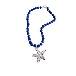 Blue beaded necklace with a silver starfish pendant featuring red and white dots