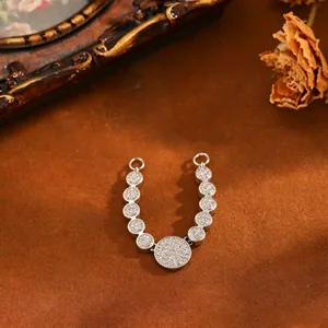 Detail shot of silver-tone copper zircon pendant with multiple pave-set circular discs