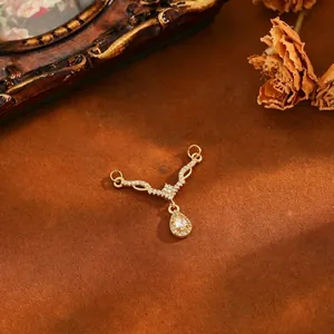 Close-up of elegant gold plated copper pendant with waterdrop zircon and star detail
