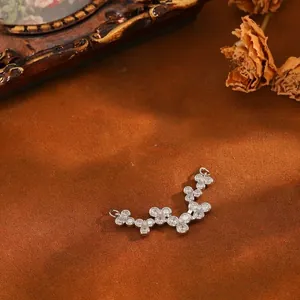 Detailed macro view of a curved silver copper pendant with sparkling zircon clusters