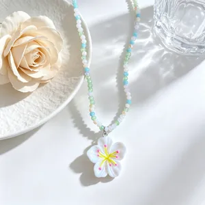Detail view of colorful beaded flower necklace featuring sweet dopamine style and pendant