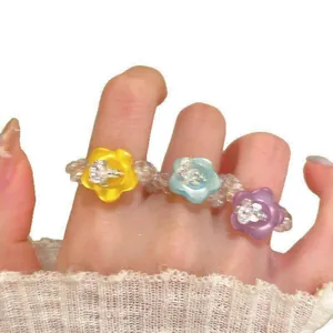 Detailed macro view of vibrant resin flower rings featuring clear glass bead bands