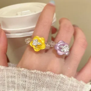 Close-up detail of a colorful dopamine resin flower beaded ring with transparent glass beads