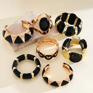 Gros plan de bracelets vintage en acrylique noir et or au design géométrique audacieux
