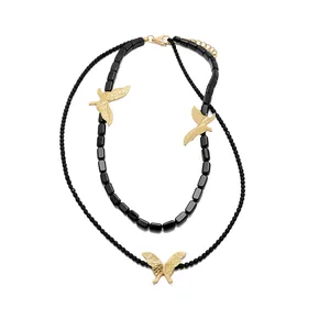 Elegant Y2K style double-layered black beaded necklace featuring gold butterfly pendants