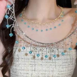 Close-up detail of vintage crystal fringe choker necklace with blue beads on a model
