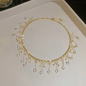 Detailed macro view of elegant gold fringed necklace with sparkling crystal drops