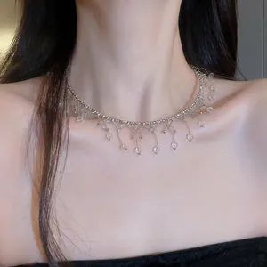 Detailed shot of an elegant silver lace choker necklace with crystal fringe tassels.
