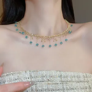 Elegant vintage lace choker necklace with blue crystal tassels on a delicate gold-tone chain.