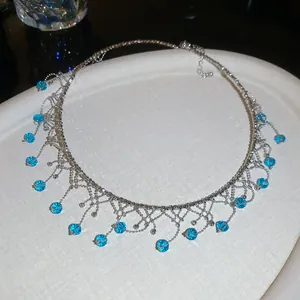 Exquisite close-up of vintage choker necklace with blue crystal fringe and silver beads