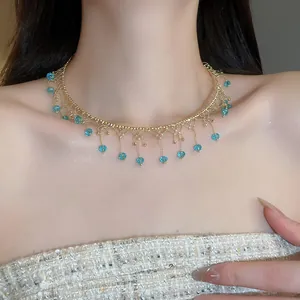 Elegant vintage style gold lace choker necklace with blue crystal fringes on a model