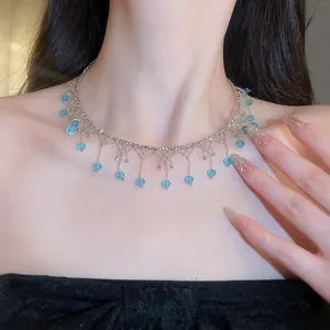 Close-up of elegant lace choker with dangling light blue crystal beads