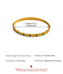 Close-up of bohemian gold flower bangle with blue rhinestones and size specifications