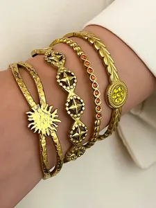 Detailed view of stacked vintage bohemian gold stainless steel bracelets with rhinestones