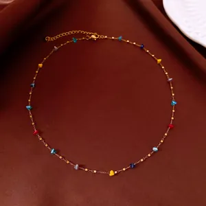 Detail of irregular colorful crystal beaded necklace with delicate gold chain for women.