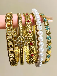 Detailed close-up of vintage bohemian gold bracelet set with pearls and rhinestones