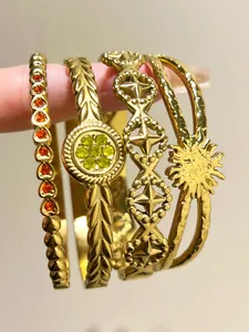 Close-up of bohemian gold stainless steel bracelets featuring intricate rhinestone details.