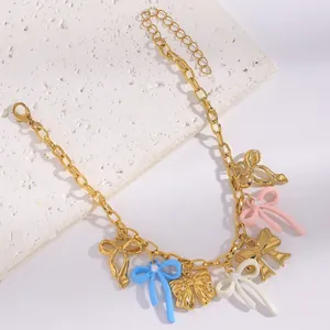 Detailed close-up showing the colorful enamel bow charms and pearls of the sweet style necklace