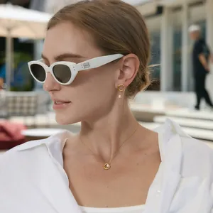 Model wearing minimalist 18k gold plated necklace and earrings jewelry set in gold