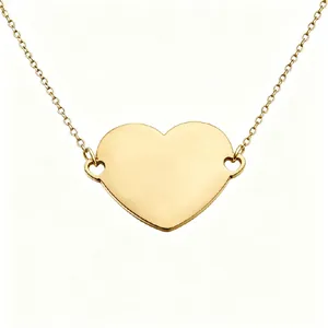 Macro view of a golden mirror finish heart pendant necklace ideal for custom DIY engraving