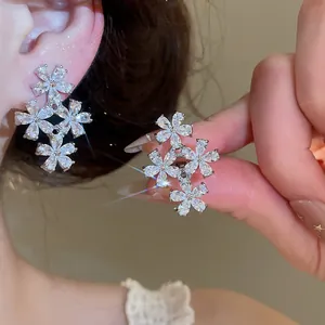Macro detail of sparkling flower earrings featuring premium cubic zirconia petals