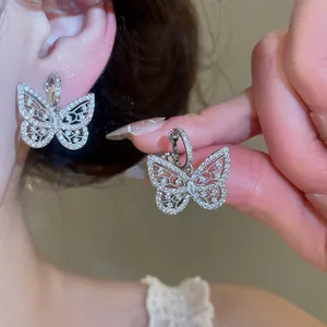 Close-up detail of sparkling silver butterfly clip-on earrings with cubic zirconia