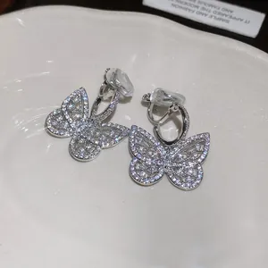 Detailed view of sparkling zircon butterfly ear clips with comfortable non-pierced design.
