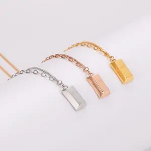 Detailed macro view of geometric gold bar pendant necklaces in gold rose and silver finish