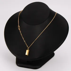 Detail of 18k gold plated stainless steel necklace with a small gold bar pendant