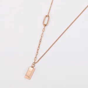 Close-up of 18k gold plated stainless steel necklace with small gold bar pendant