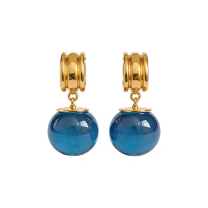 Boucles d'oreilles créoles dorées avec pendentifs boules en résine bleu foncé translucide