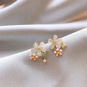 Elegant flower petal stud earrings featuring cat eye stones and pink bead accents