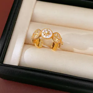 Primer plano detallado del anillo abierto estrella bañado en oro 18K con circonitas