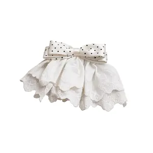 Elegant white lace hair clip featuring a delicate black polka dot ribbon bow design for women